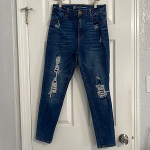 Dark blue stretchy jeans with false rips on the front and a size 13 juniors